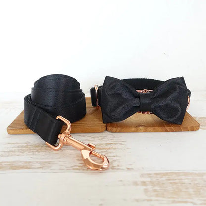 Elegant black bow tie collar for pets with a sleek metal buckle, combining style and practicality for special occasions or daily walks