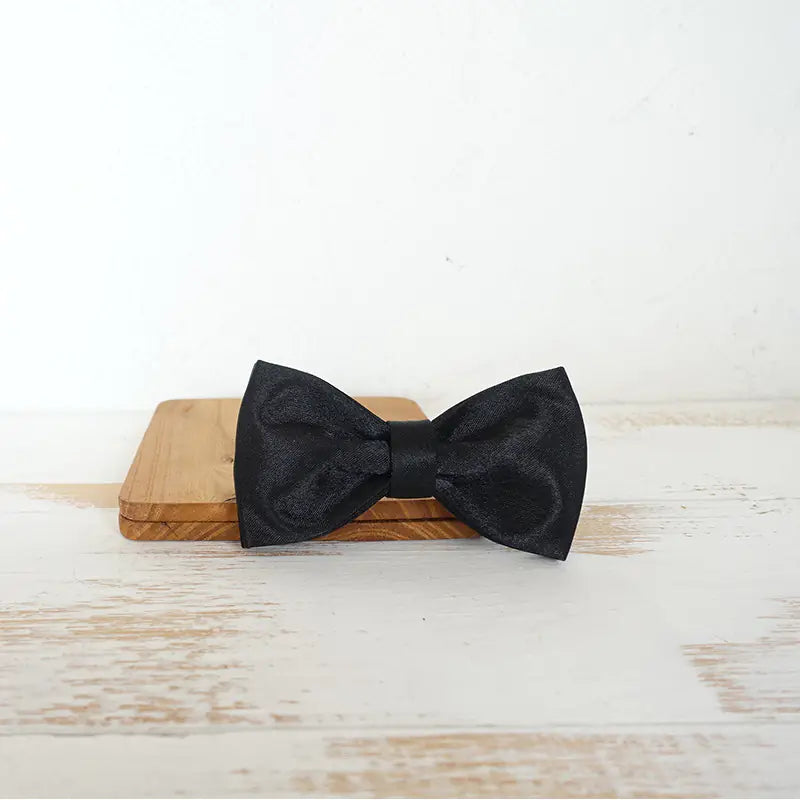 Elegant black bow tie collar for pets with a sleek metal buckle, combining style and practicality for special occasions or daily walks
